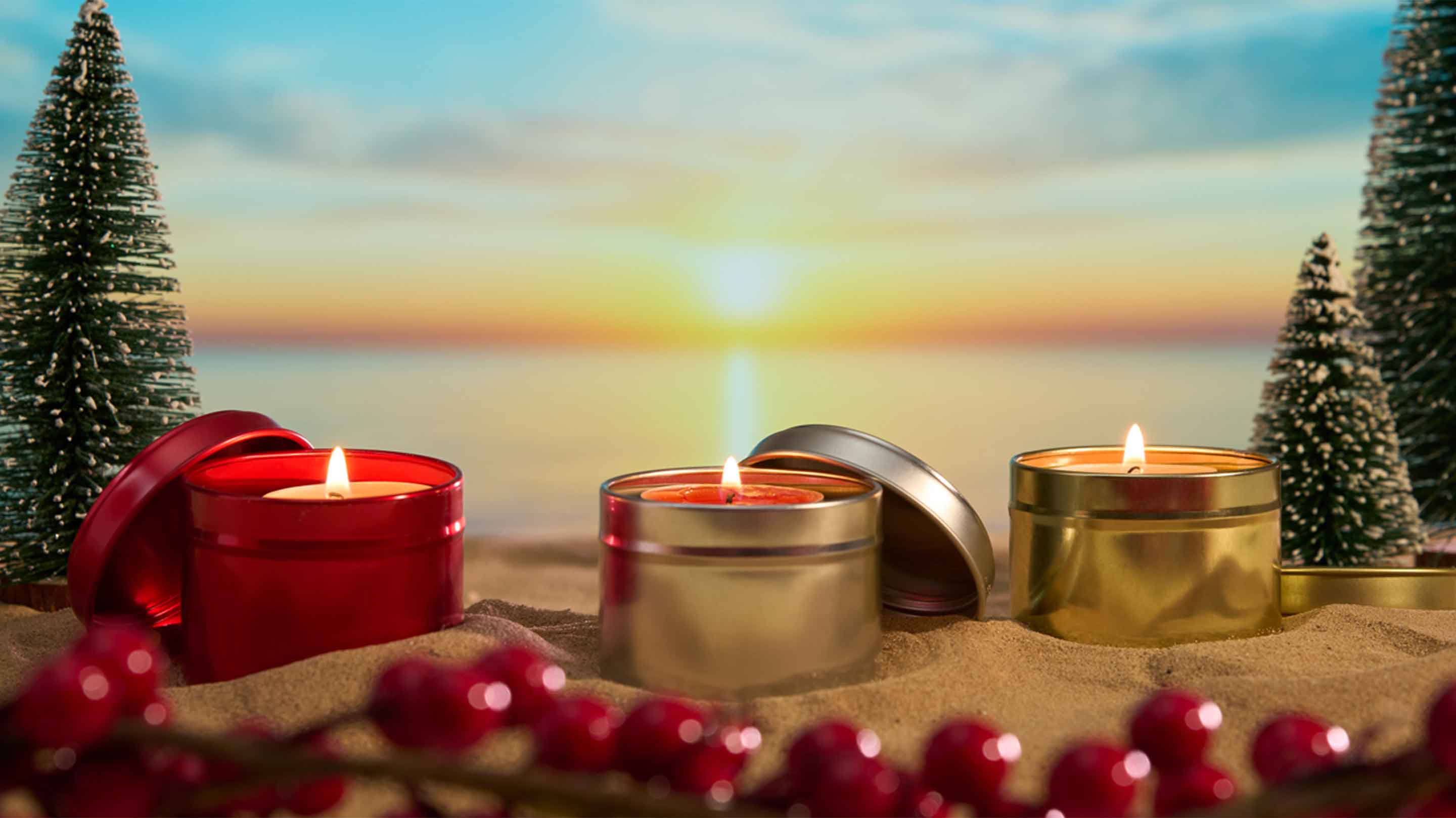 Christmas candle packaging on a beach