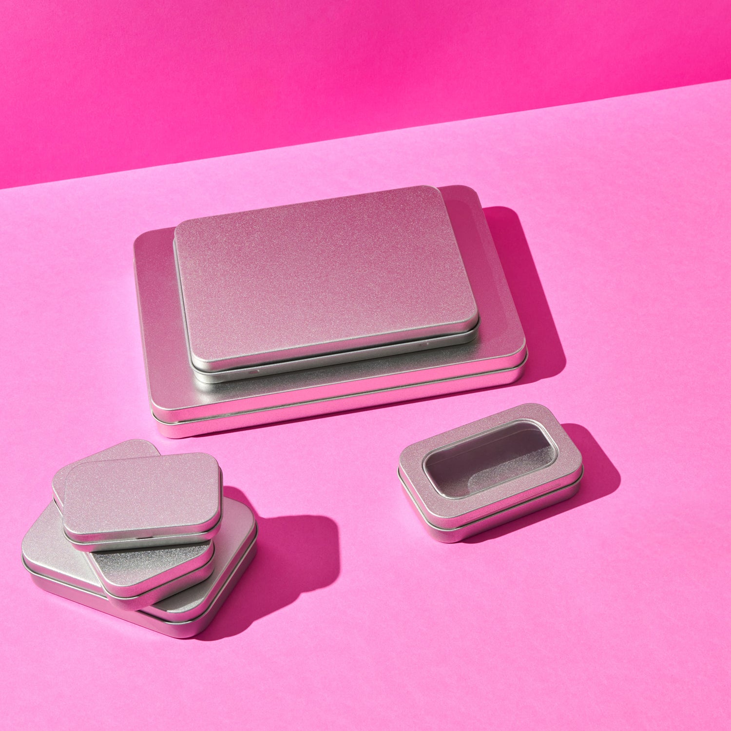 A collection of different sized rectangular stationery tins.