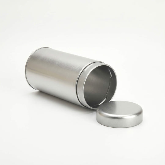 Open round silver tea tin with removable slip lid shown from side angle on white background.